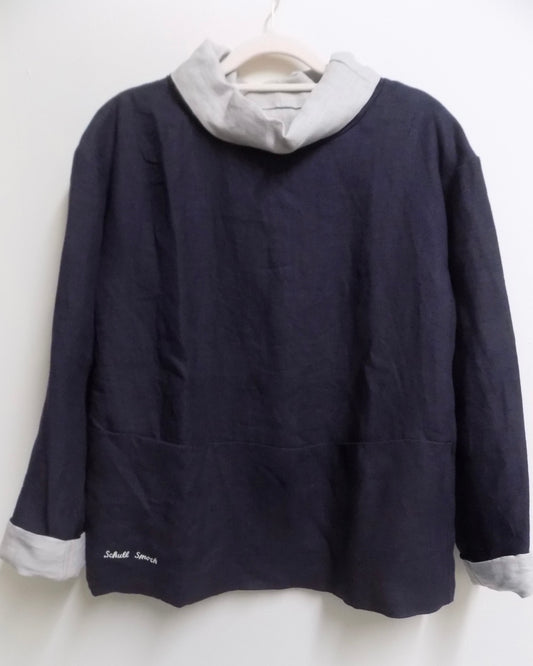 A dark navy sailing smock with big front pockets with contrasting collar and cuffs